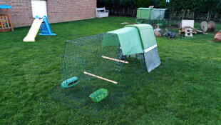 Omlet green Eglu Go up raised chicken coop and run in the garden